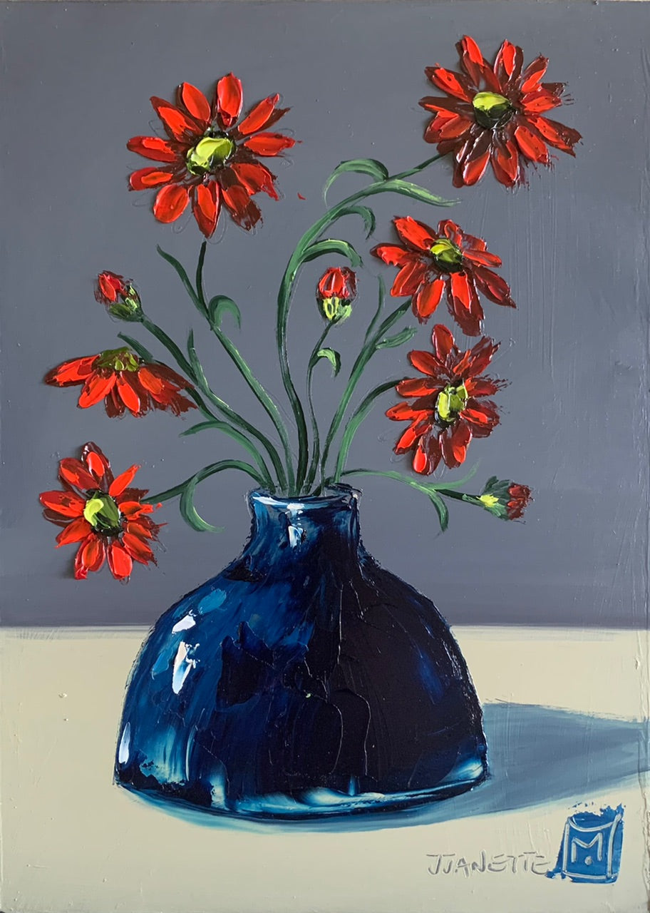 Red daisies in blue vase